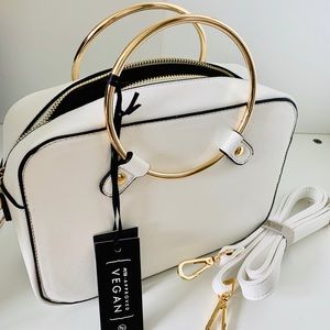 White Metal Ring Handbag with gold tone handles.